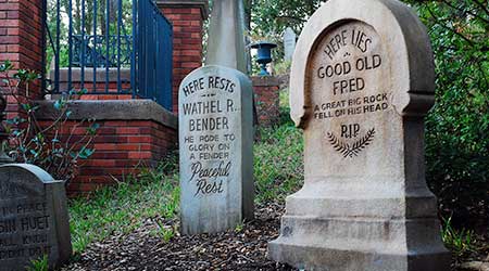 The entrance to the Haunted Mansion is lined with humorous tombstones