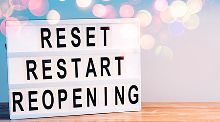 Words reset, restart and reopening on the light box. New life, new business, new deals concept.