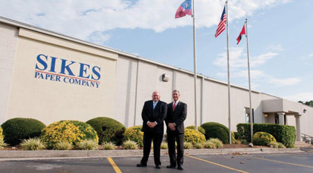 Two men in front of building