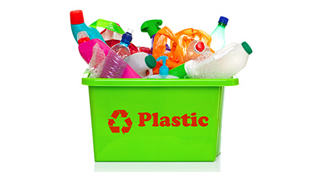 Photo of a green plastic recycling bin isolated on a white background