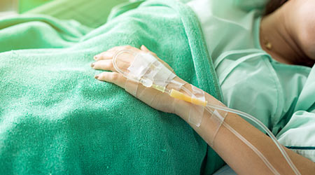 Close up of a woman patient in hospital with saline intravenous