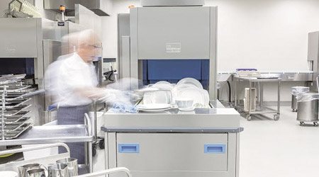 A man using a dishwashing machine