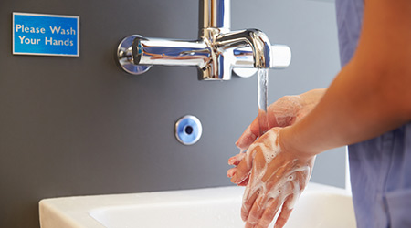 Close Up Of Medical Staff Washing Hands