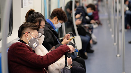 New type coronavirus 2019-nCoV pneumonia in Wuhan has been spreading into many cities in China. People wearing surgical mask sitting in subway in Shanghai