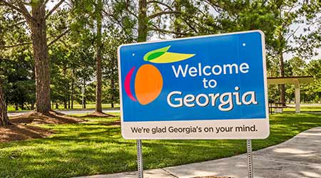 A sign welcoming people to the state of Georgia with reference to "Georgia's On My Mind"