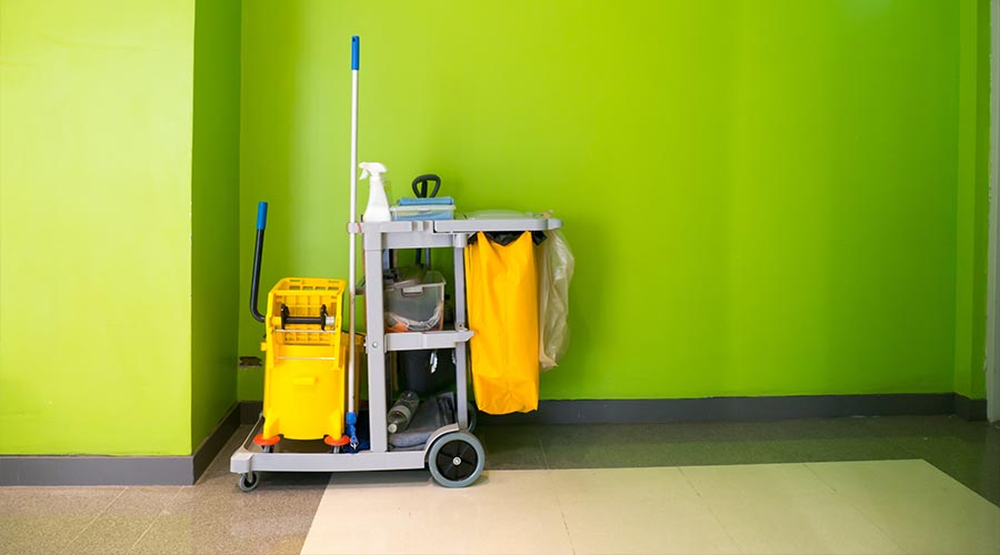 Cleaning tools cart wait for cleaning. Bucket and set of cleaning equipment in the office. cleaning services concept