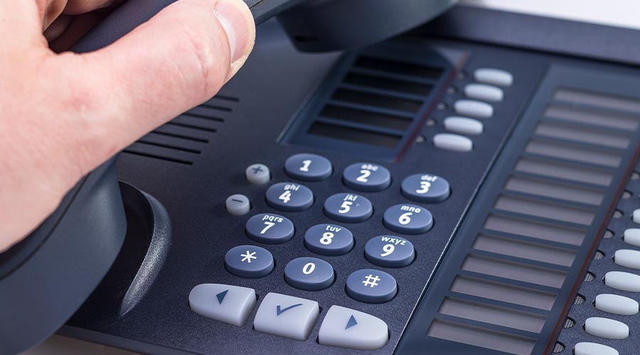 The photo shows a male hand on the phone isolated on white