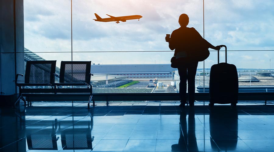 travel by plane, woman passenger waiting in airport, silhouette of passenger watching aircraft taking off